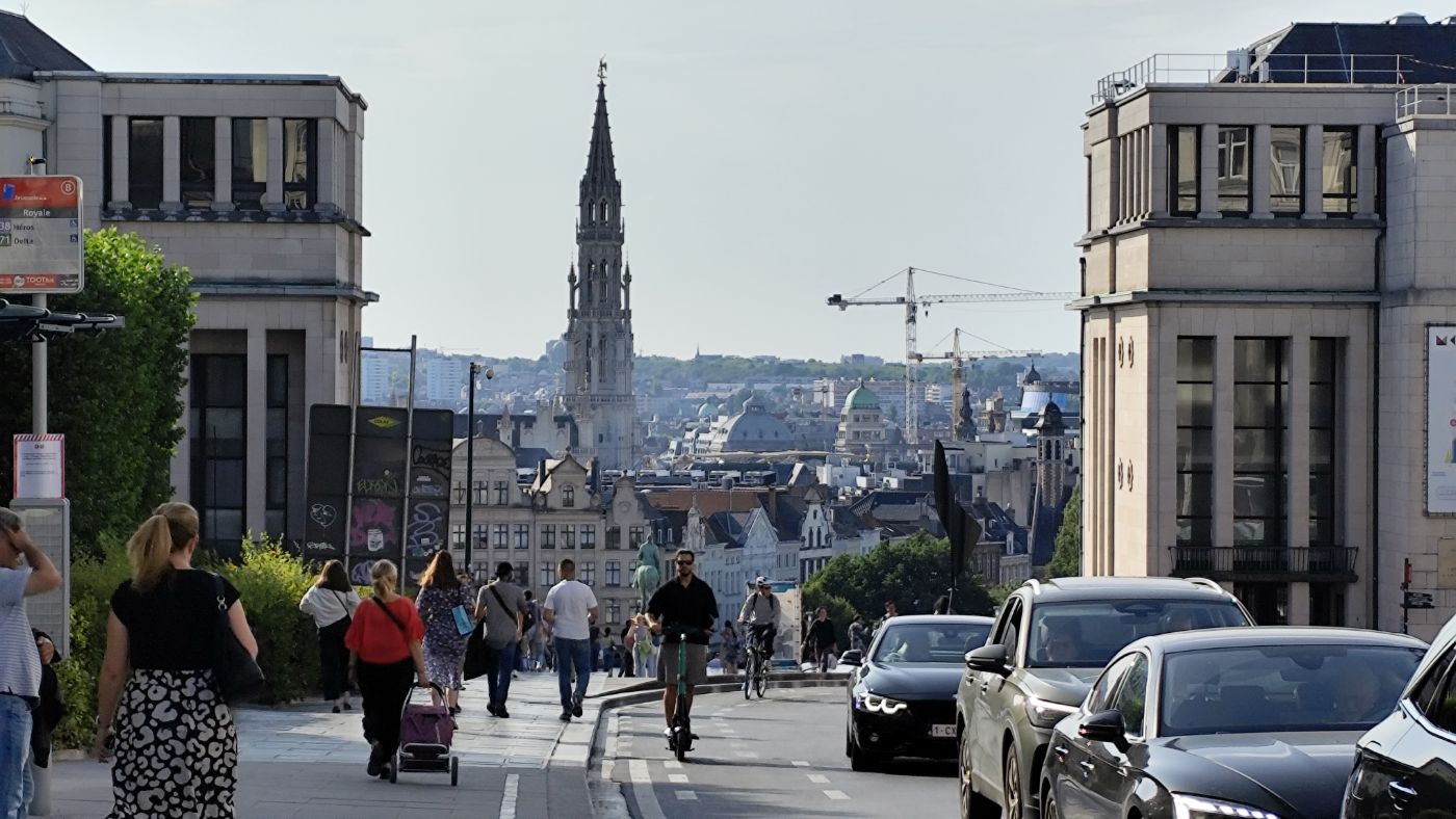A city street descending towards a gothic tower