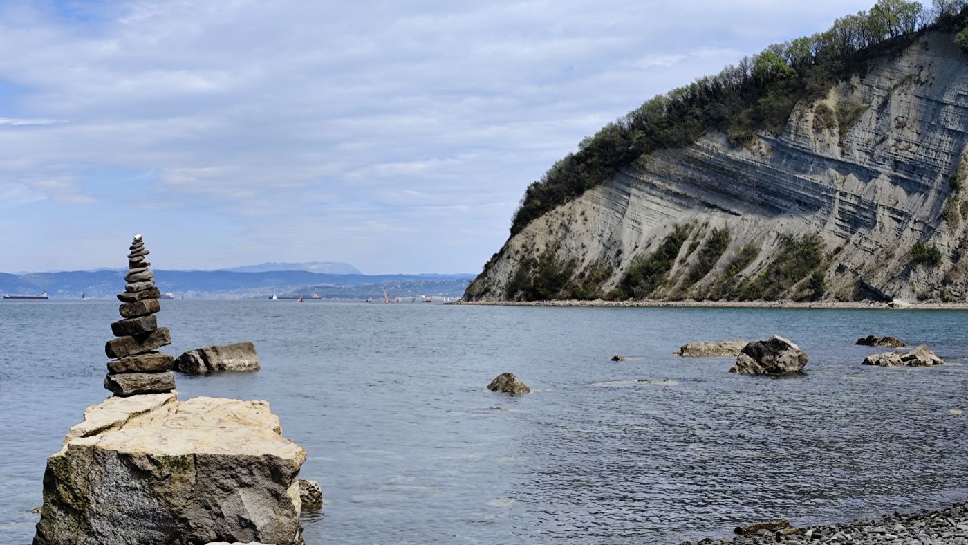 A stone cairn on the Adriatic coast below a flysch cliff