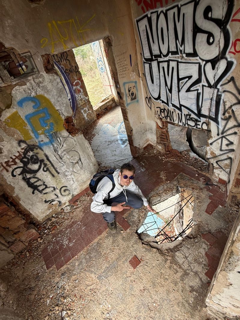 Crouching in a ruined building full of graffiti