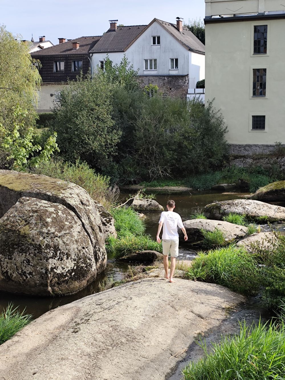 Walking barefoot over granite boulders in a river