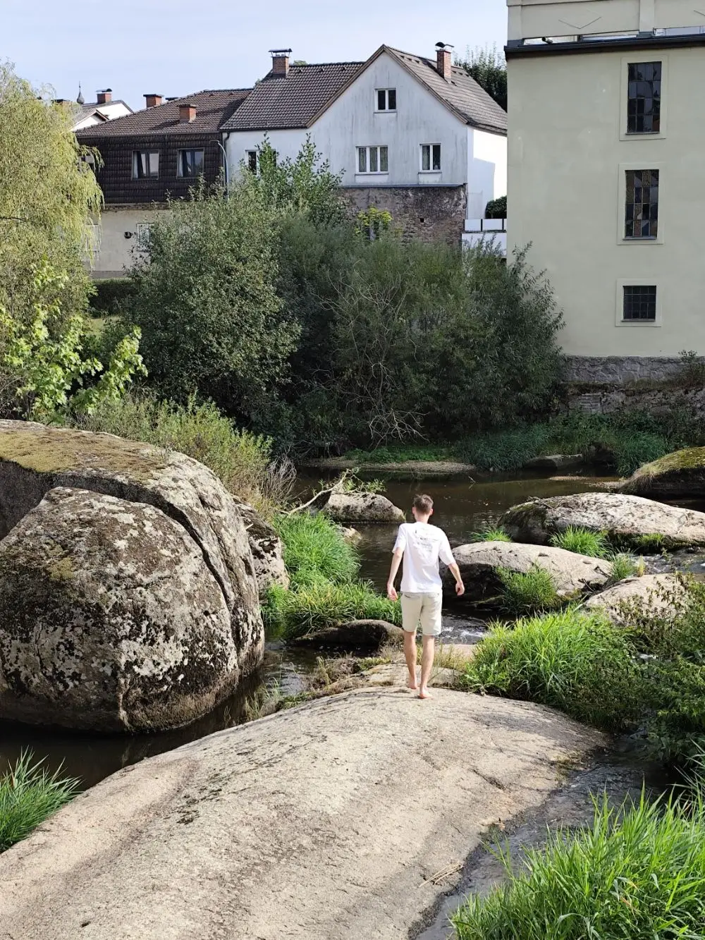 Walking barefoot over granite boulders in a river