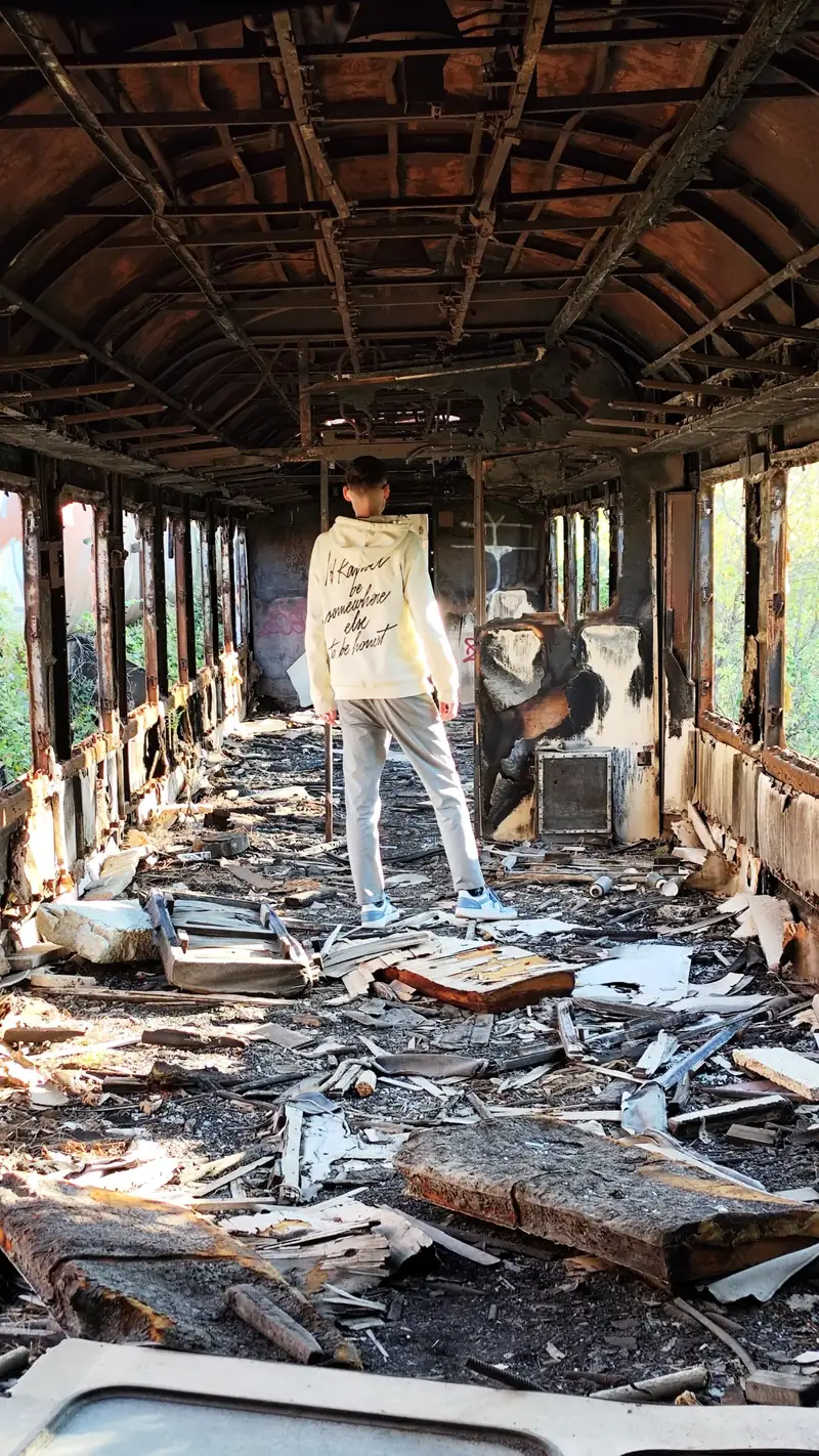 Standing inside a burnt-out railway carriage